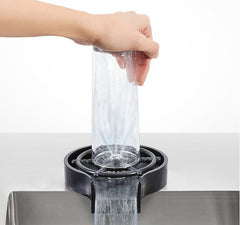 Person using a water dispenser with a clear container, white background