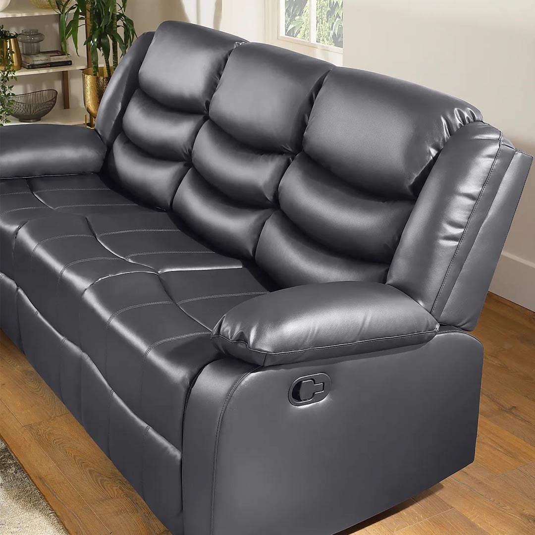 "Stylish grey leather sofa with reclining comfort, ideal for modern living rooms."