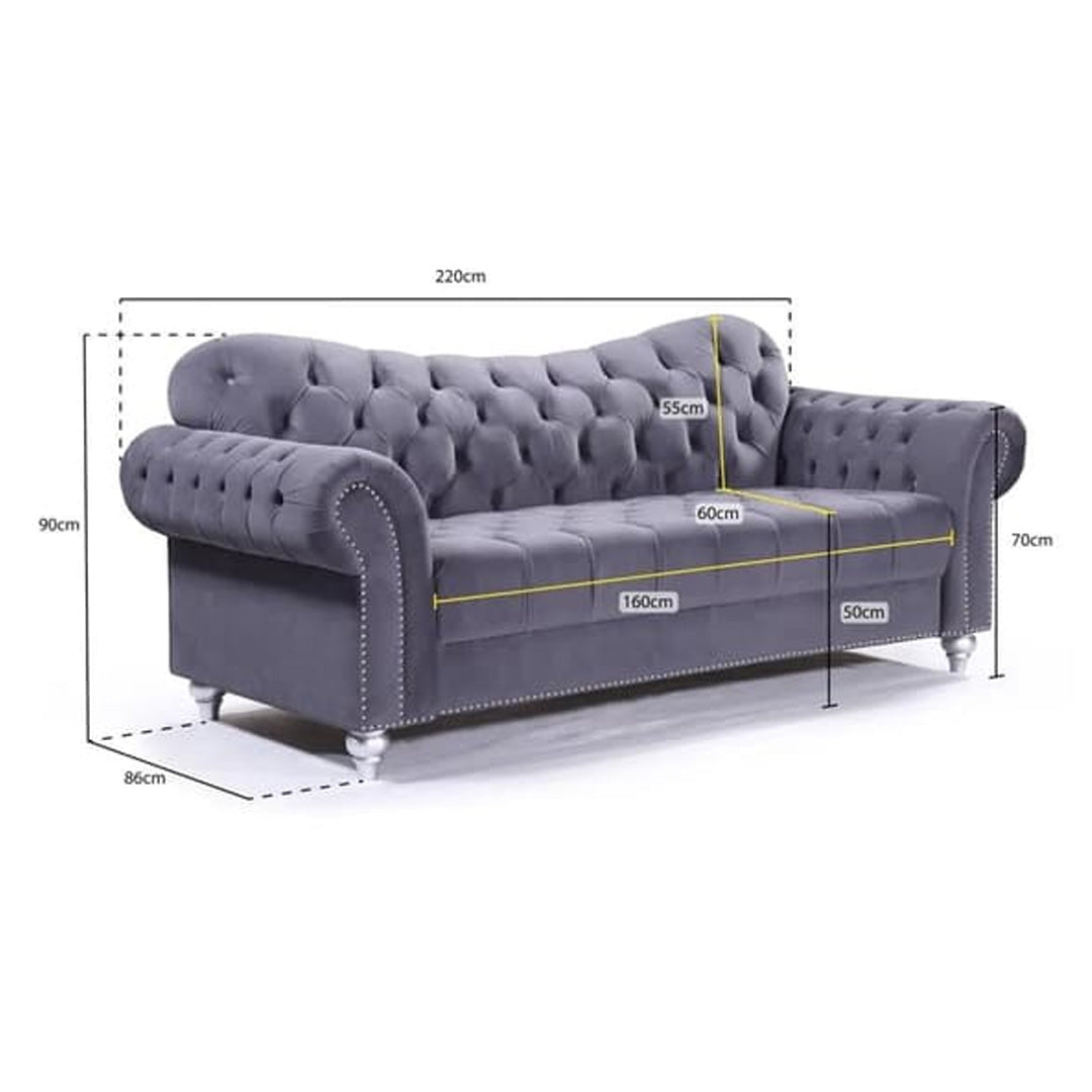"Grey velvet Chesterfield 3-seater sofa in a stylish living room, blending modern comfort with classic charm for a sophisticated look."