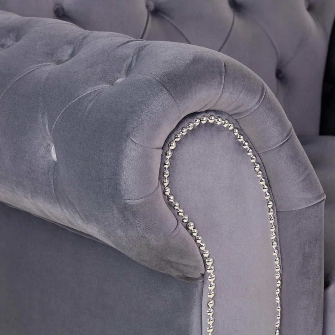 "Modern Jubilee Grey Corner Sofa with angular arms and soft velvet fabric"