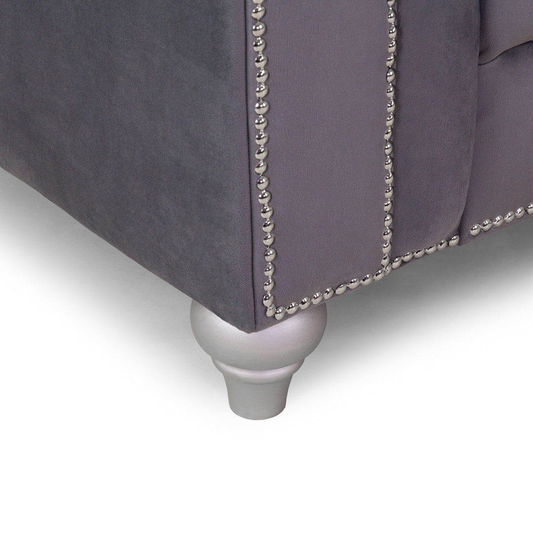 "Plush 2 seater grey fabric sofa featuring tufted detail and sturdy chrome legs"