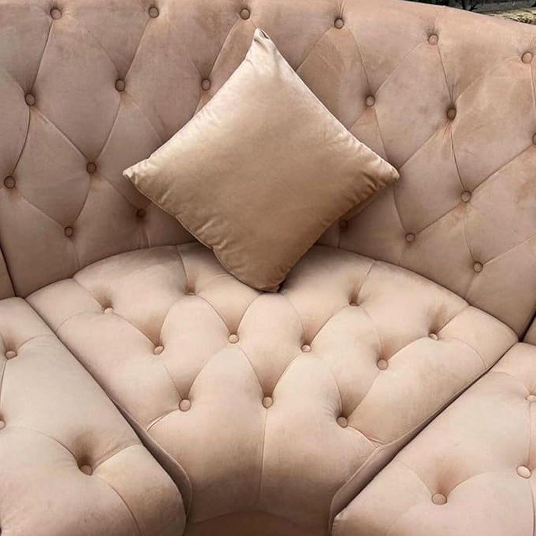 "Victorian style beige velvet corner sofa with accent pillows"