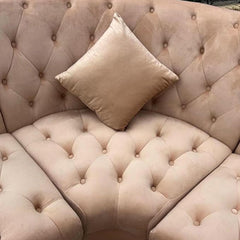 "Victorian style beige velvet corner sofa with accent pillows"